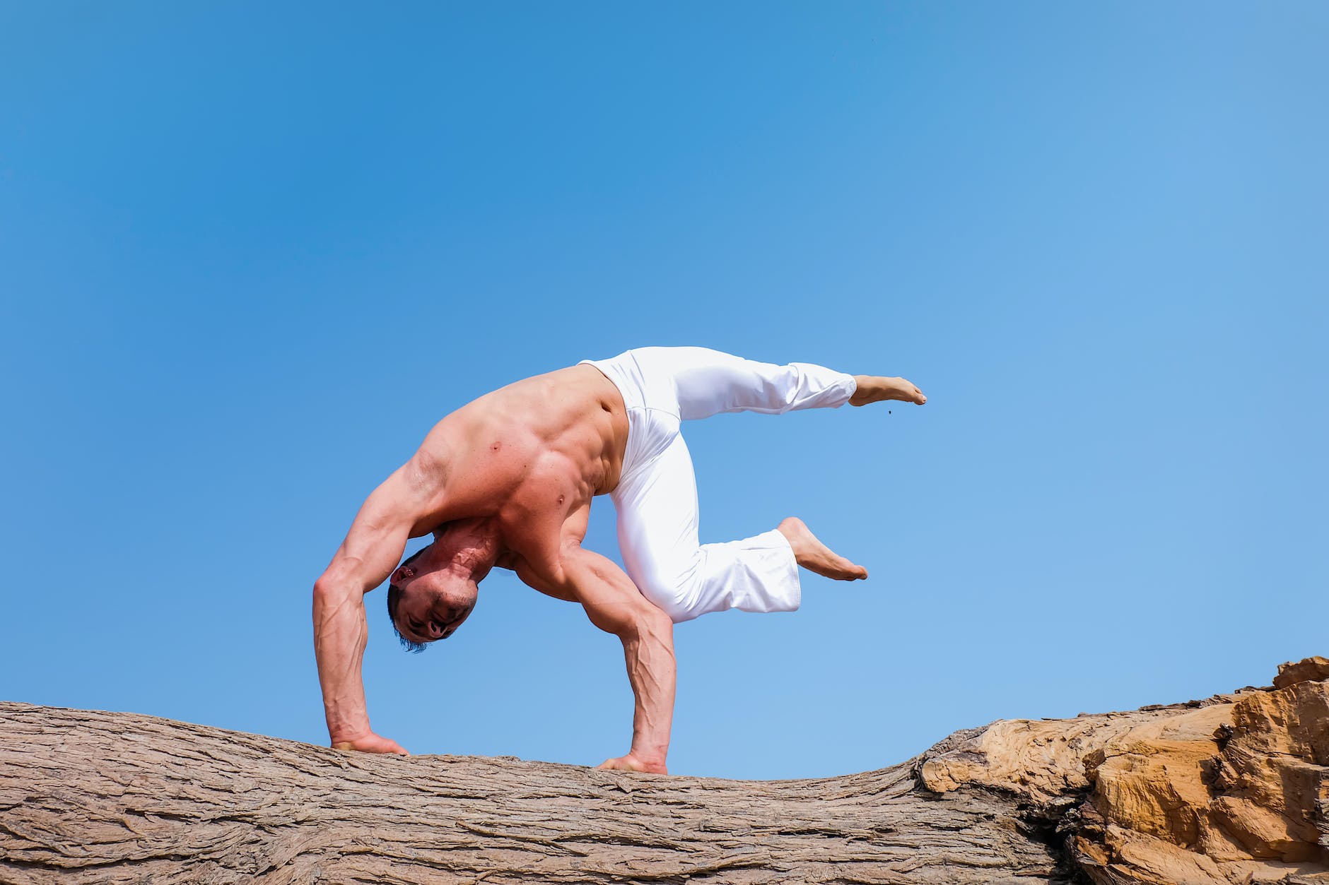 person wearing white pants under blue sky