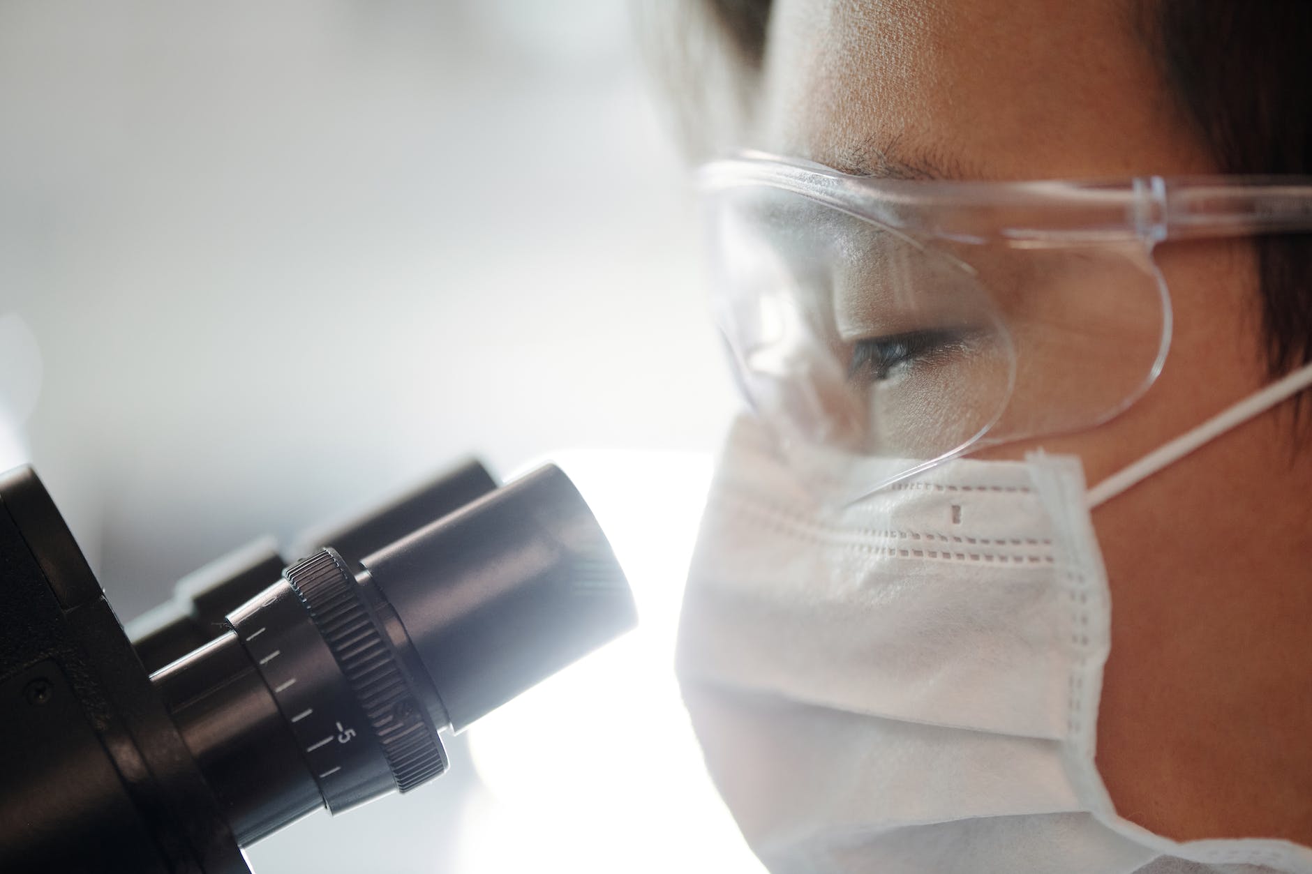 person looking through a microscope