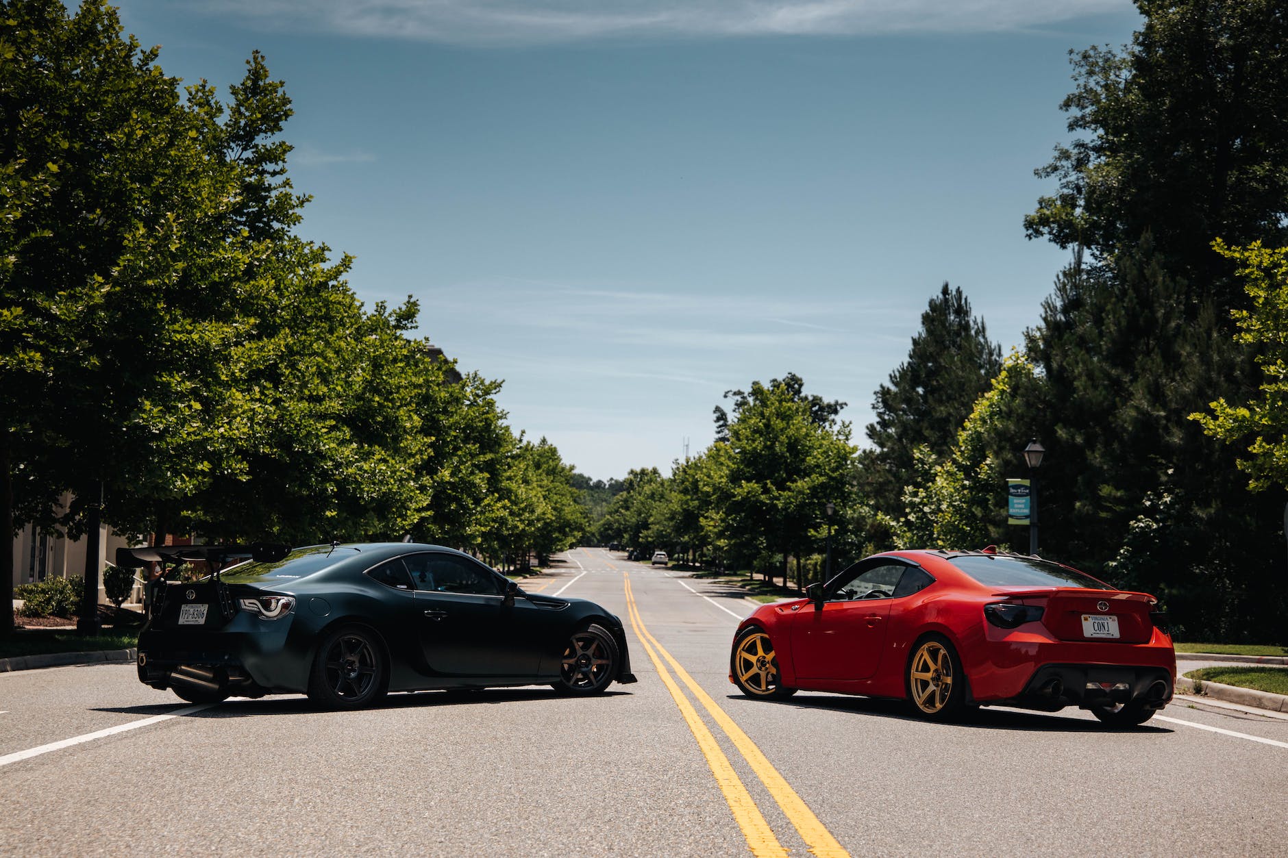 red band black sports cars parked on street