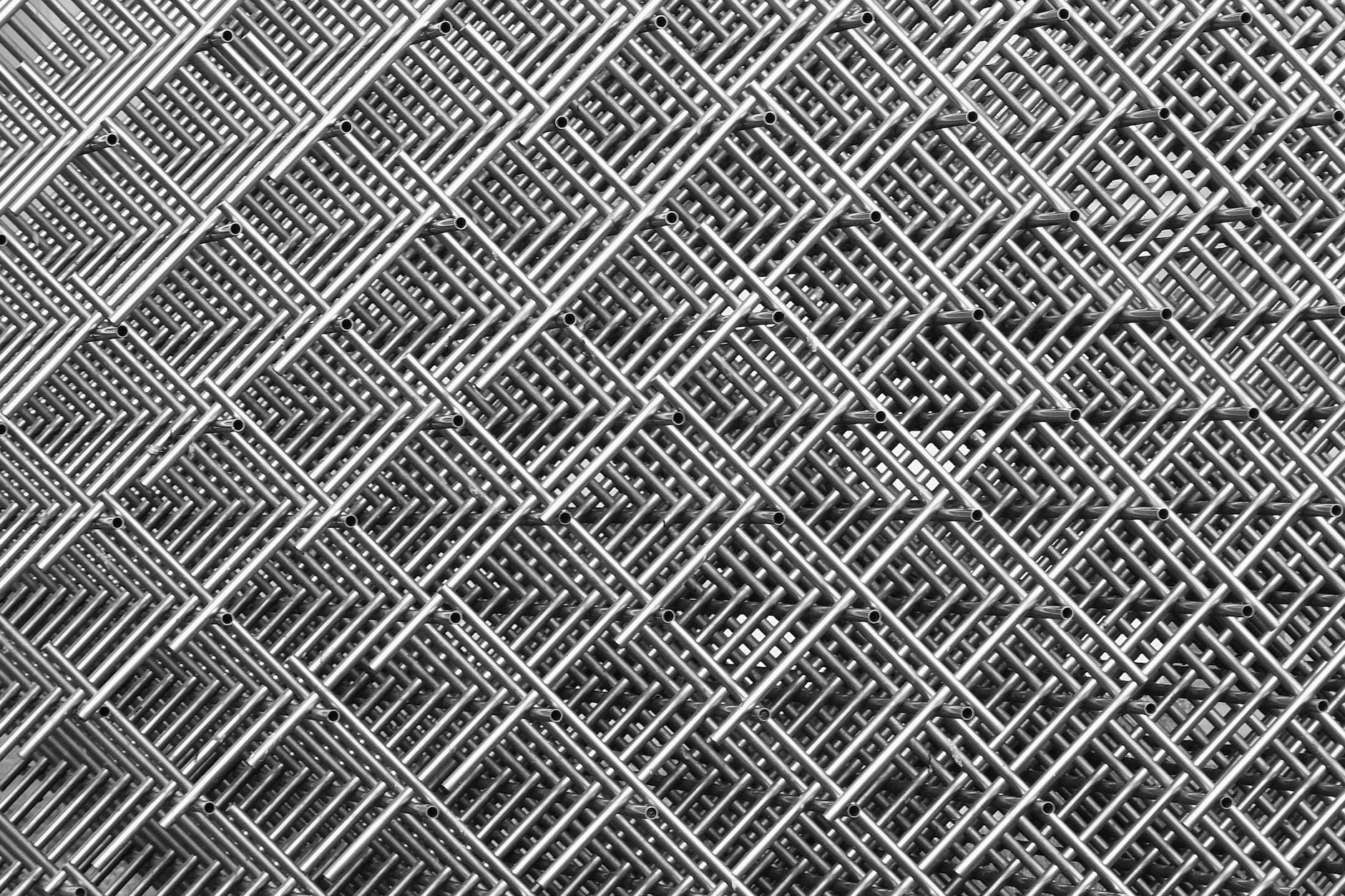 gray and black abstract artwork with perpendicular tubes forming patterns