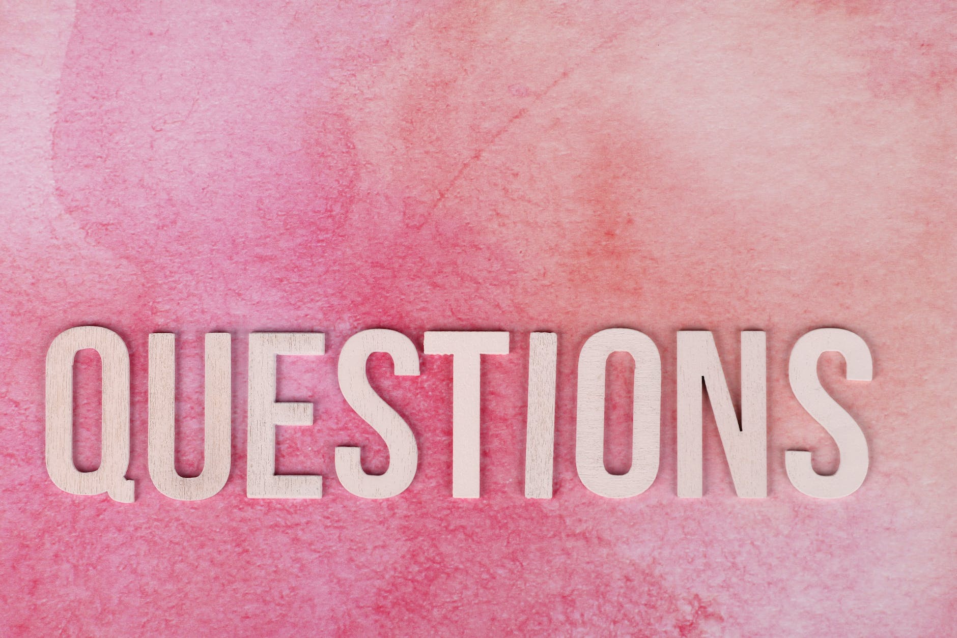 Questions text on pink surface