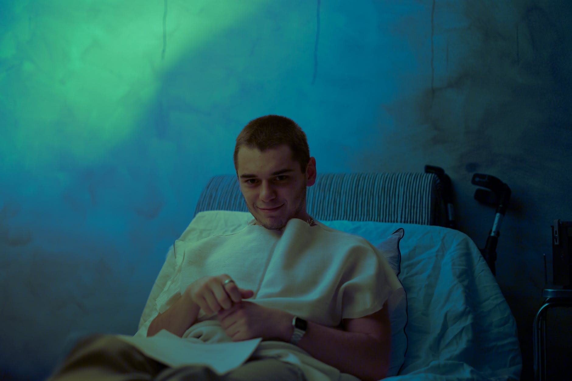 man in bed in dark room staring at us