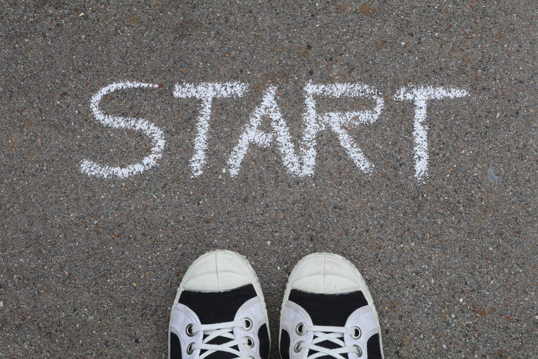 start written on asphalt in white chalk