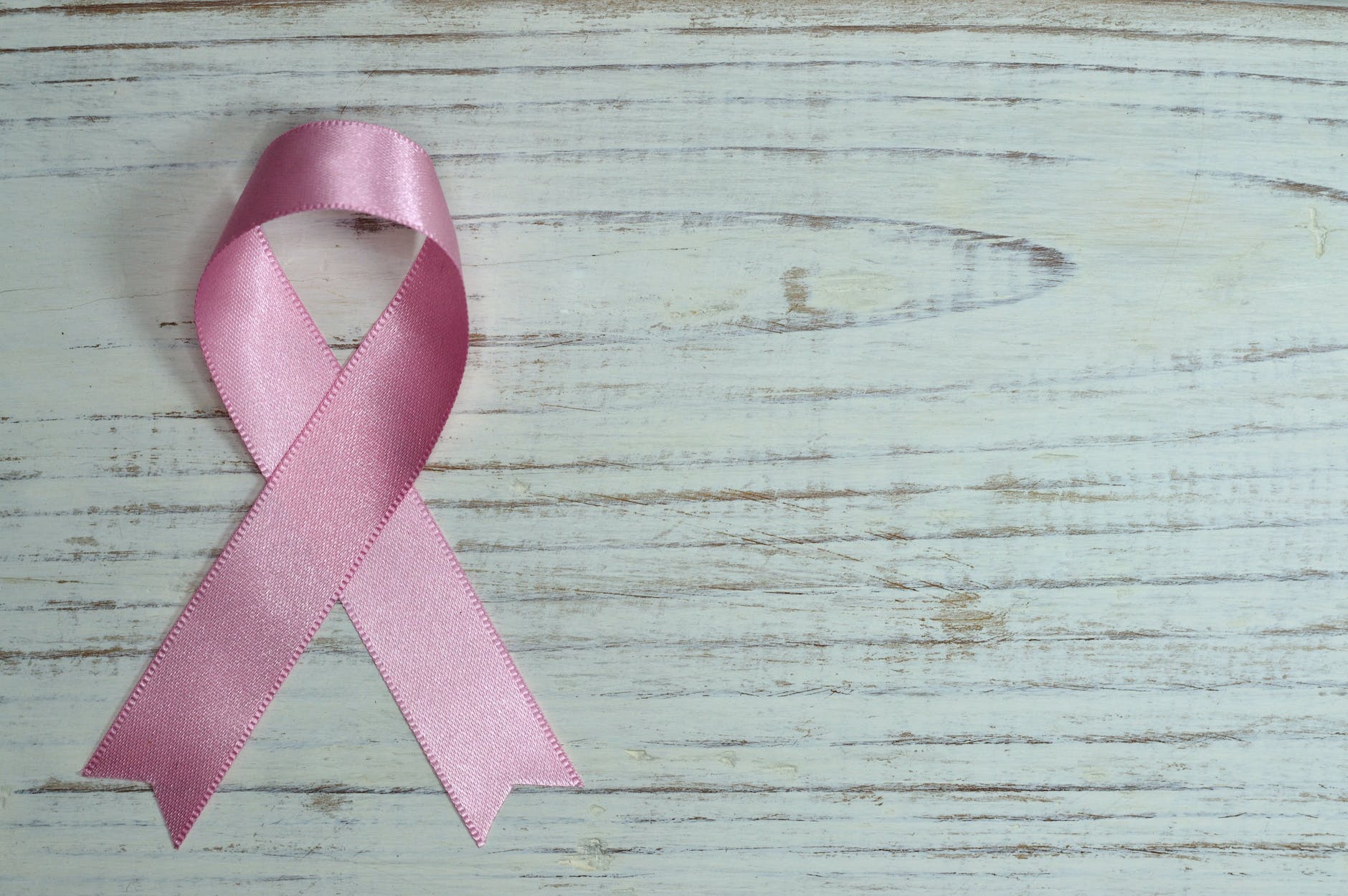 breast cancer awareness test on wooden surface