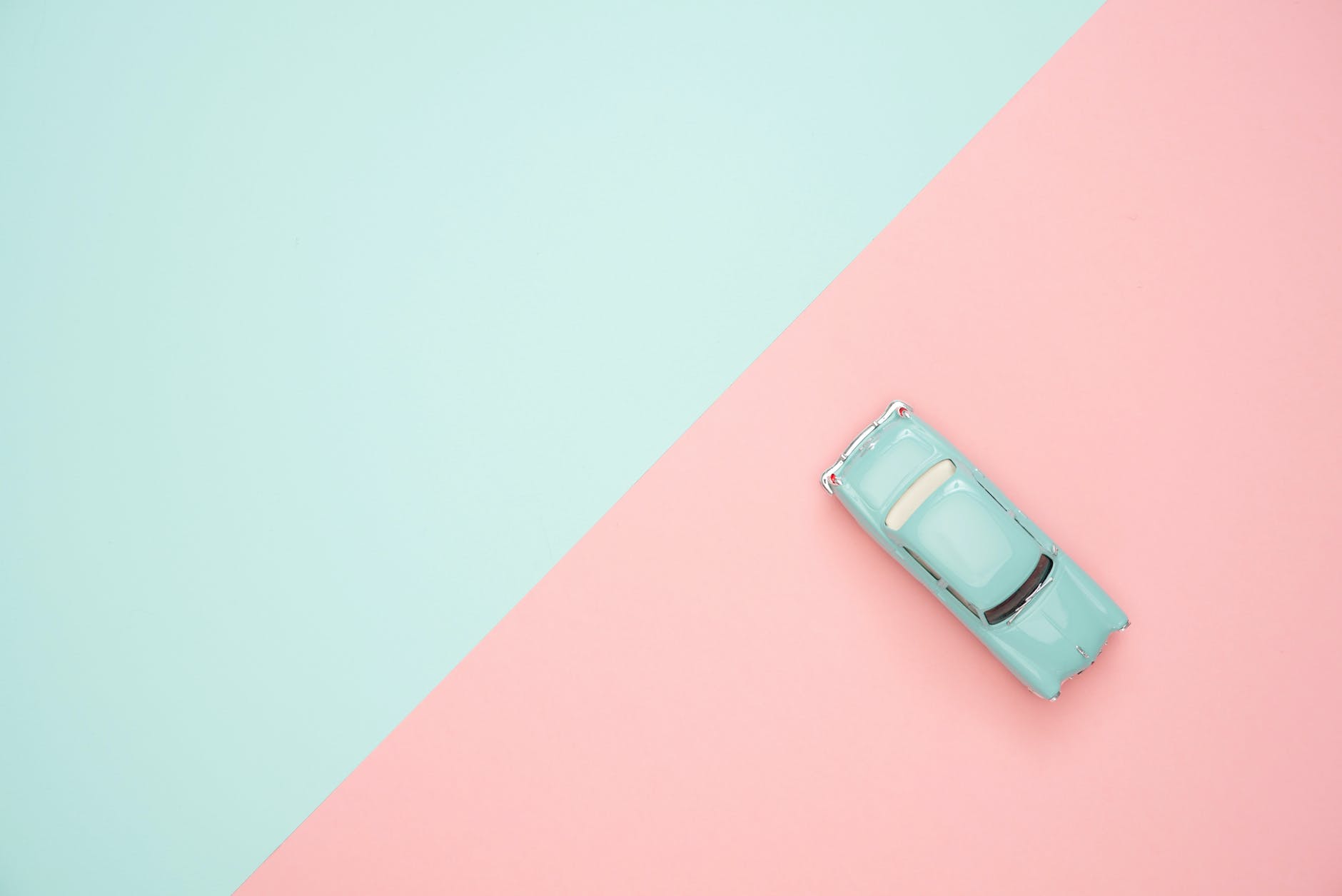 classic blue coupe die-cast model and green/pink background