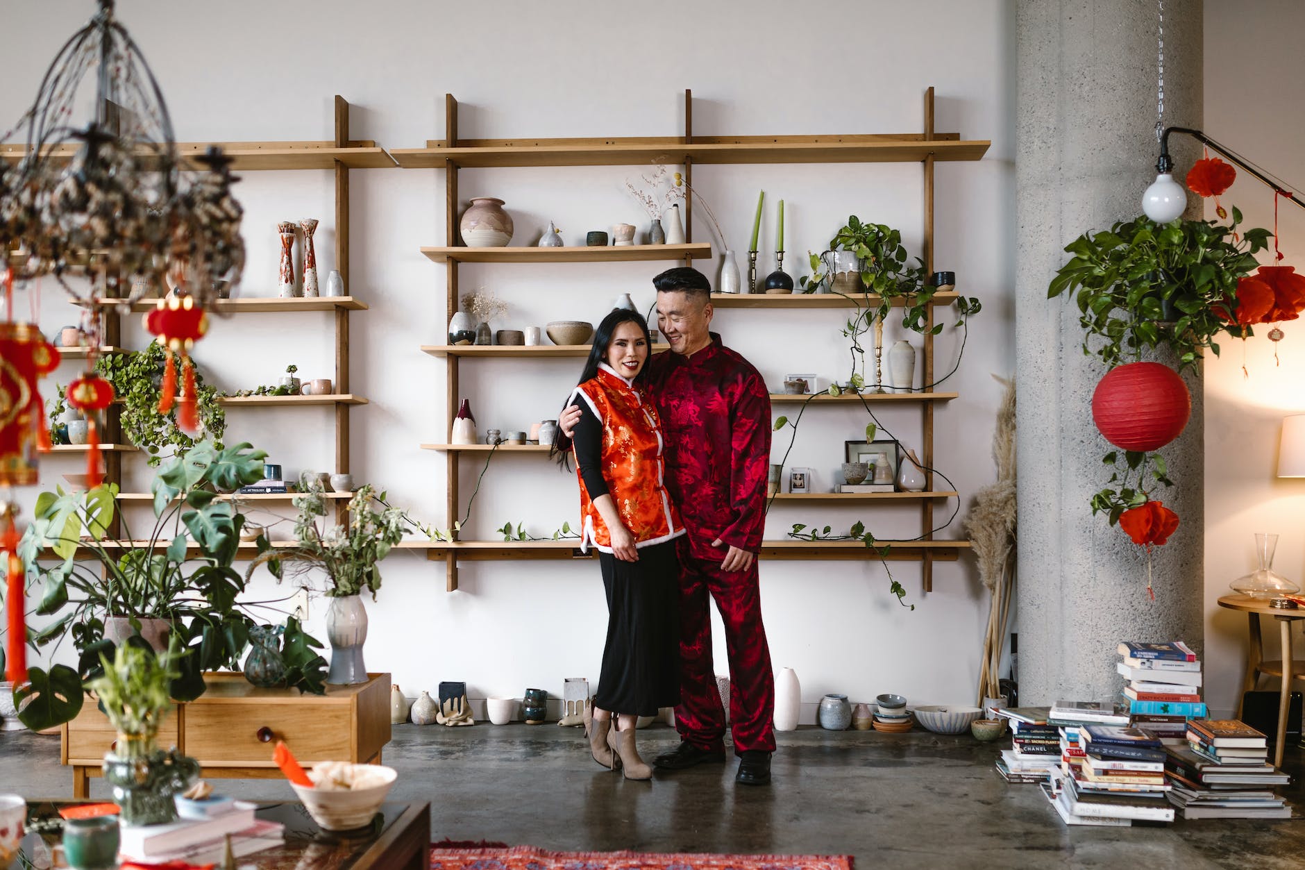 adult couple standing next to book cases