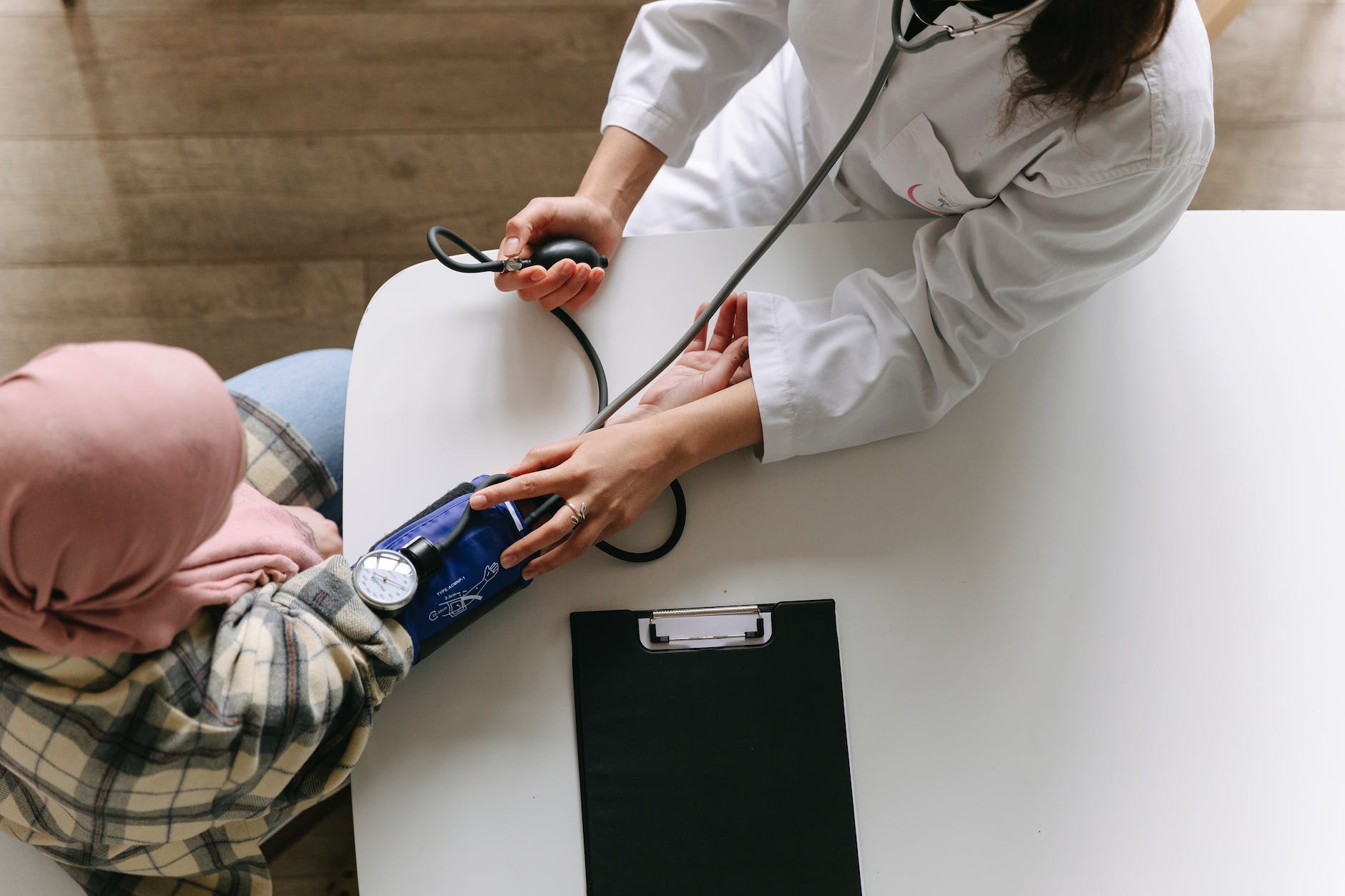 a doctor taking patient's blood pressure