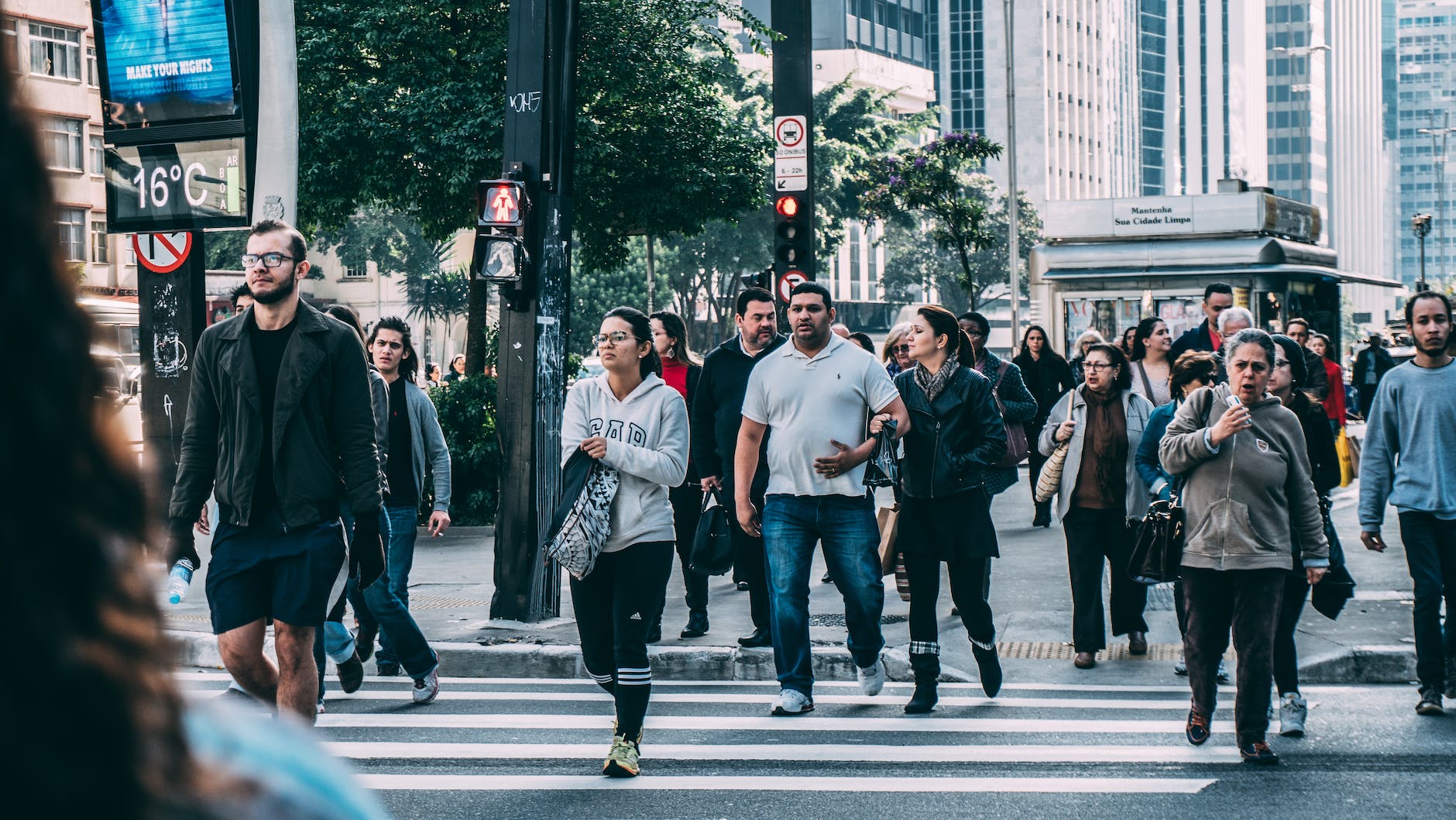 people walking on sidewalk of busy street