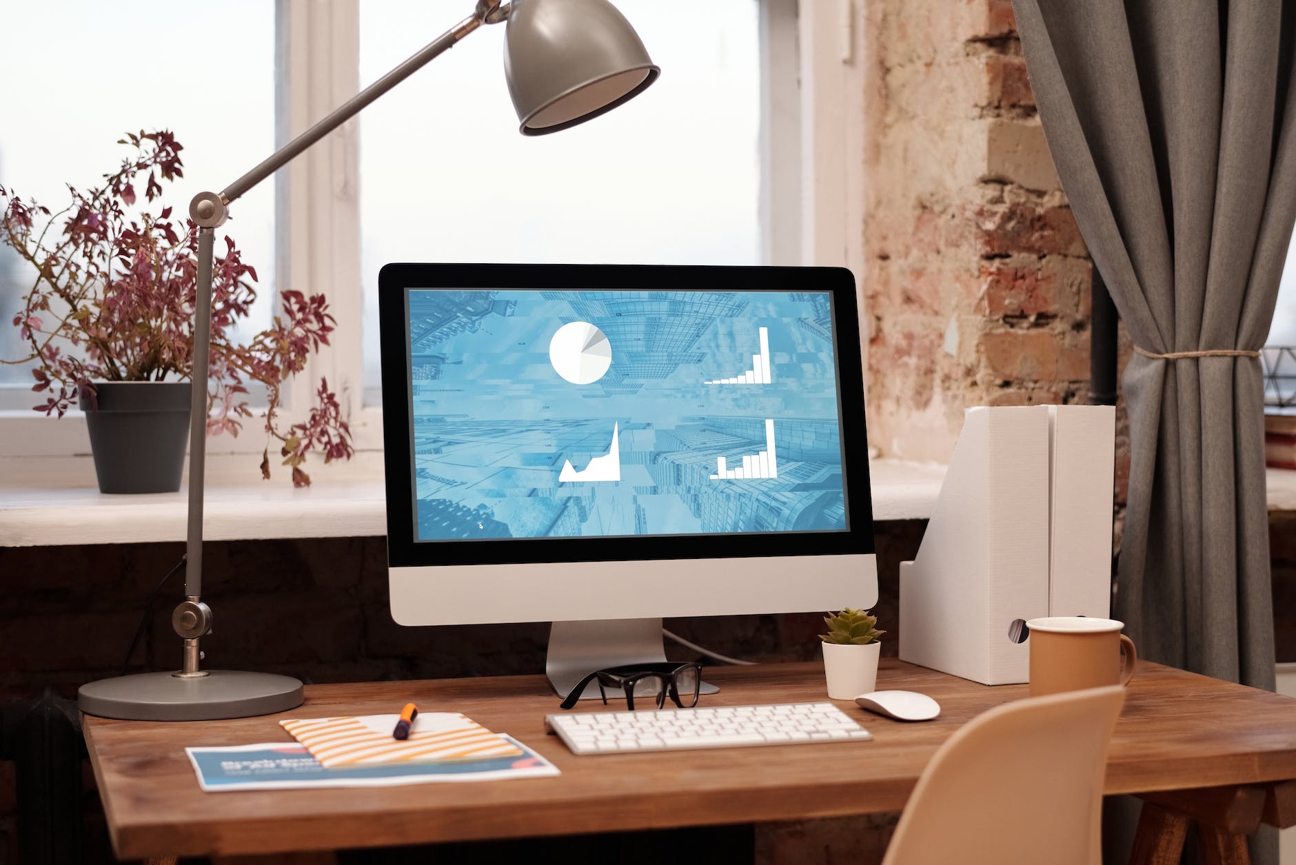 desktop computer with graphs on screen