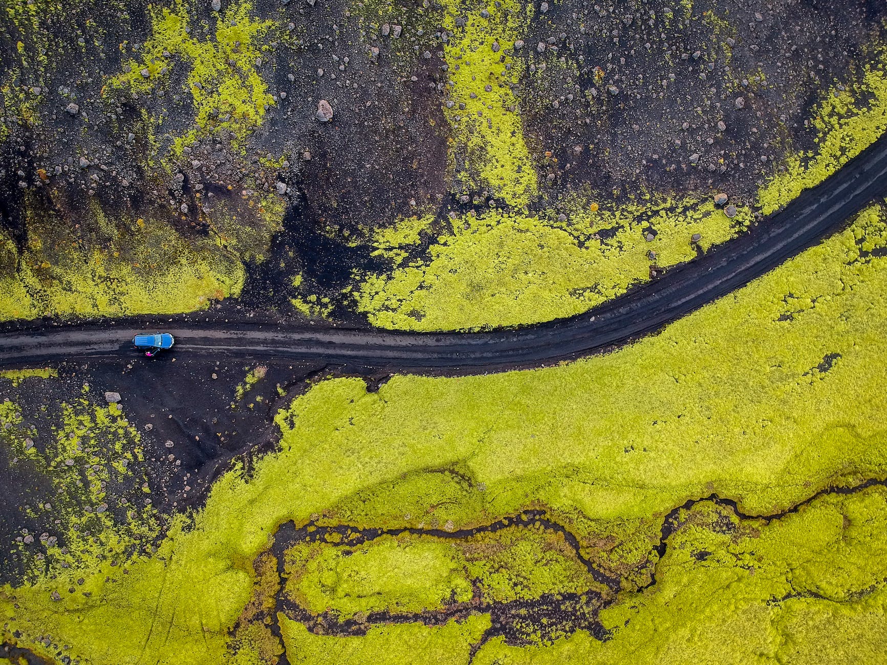 aerial view of green field and road