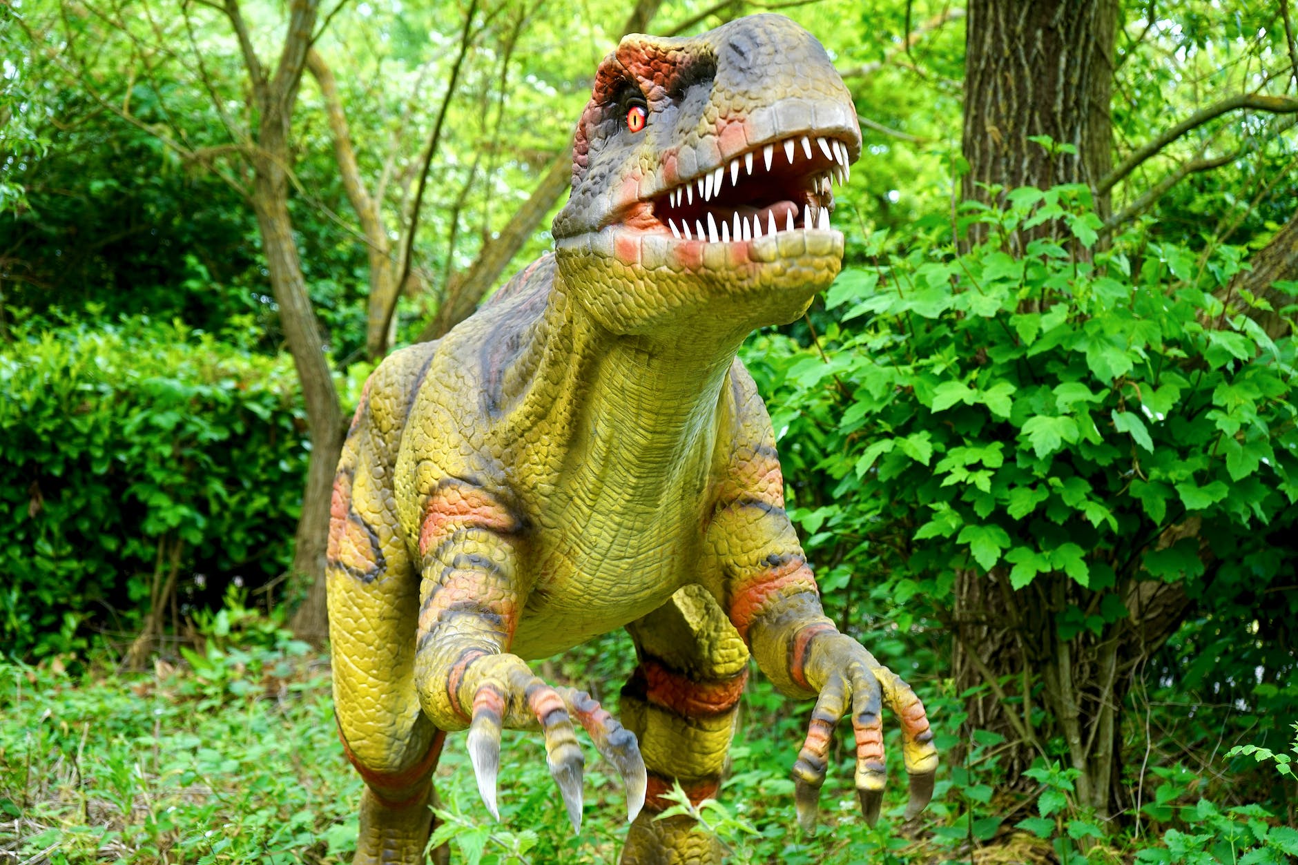 plastic dinosaur in lush green setting
