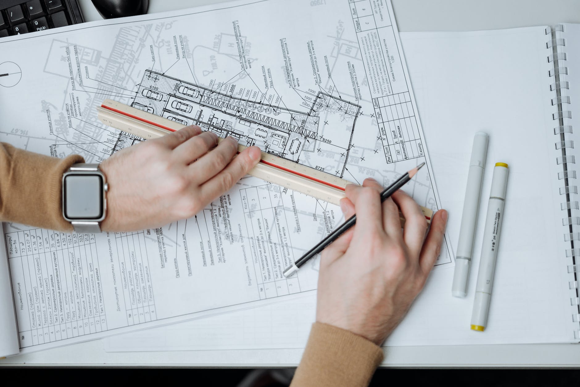 person holding pencil and ruler