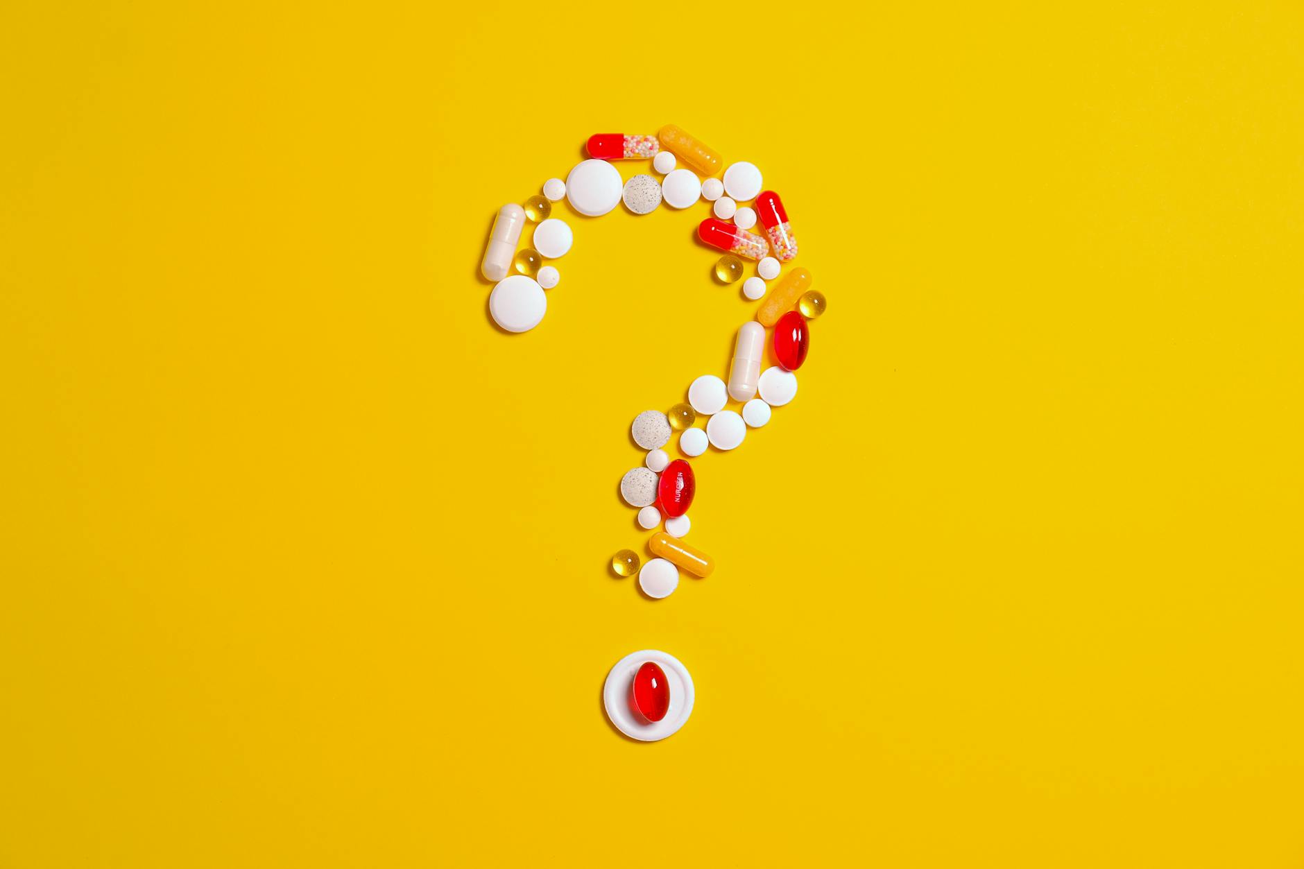 question mark composed of pills and supplements