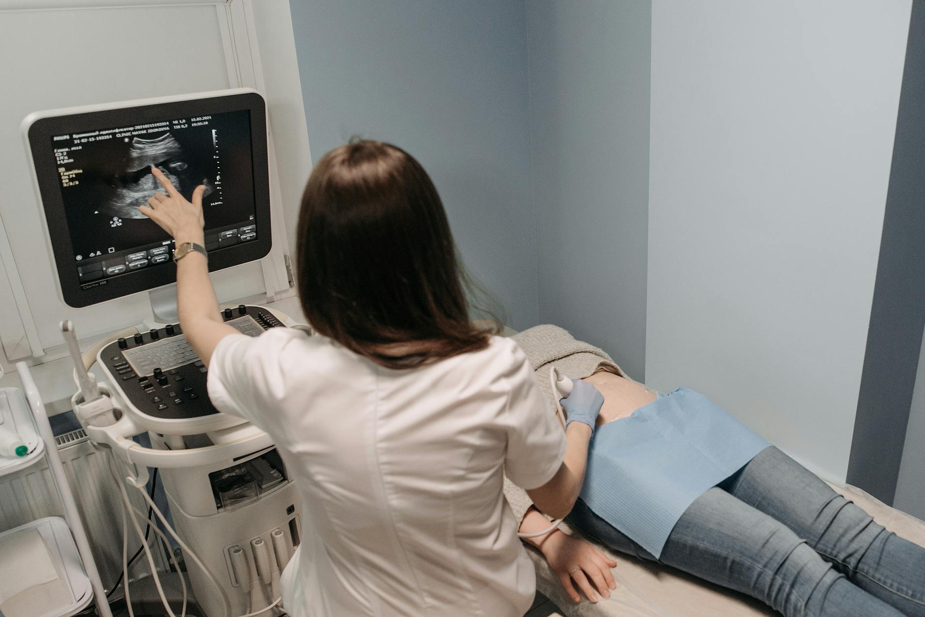 clinician performing ultrasound on patient