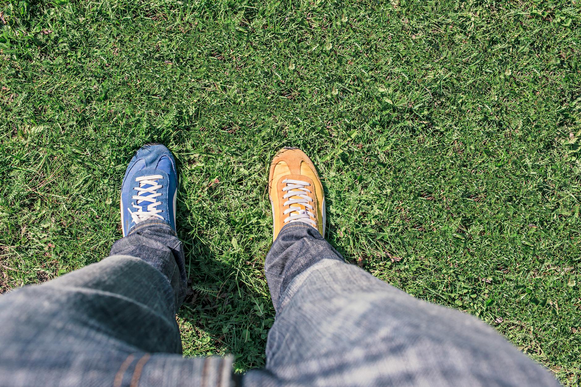 top down view of two shoes one blue and one brown