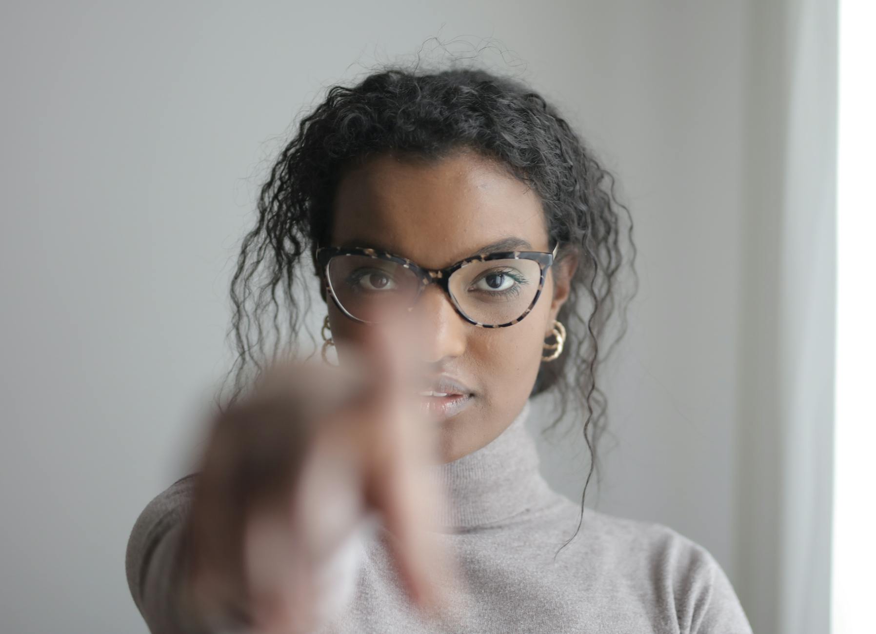 woman pointing to camera