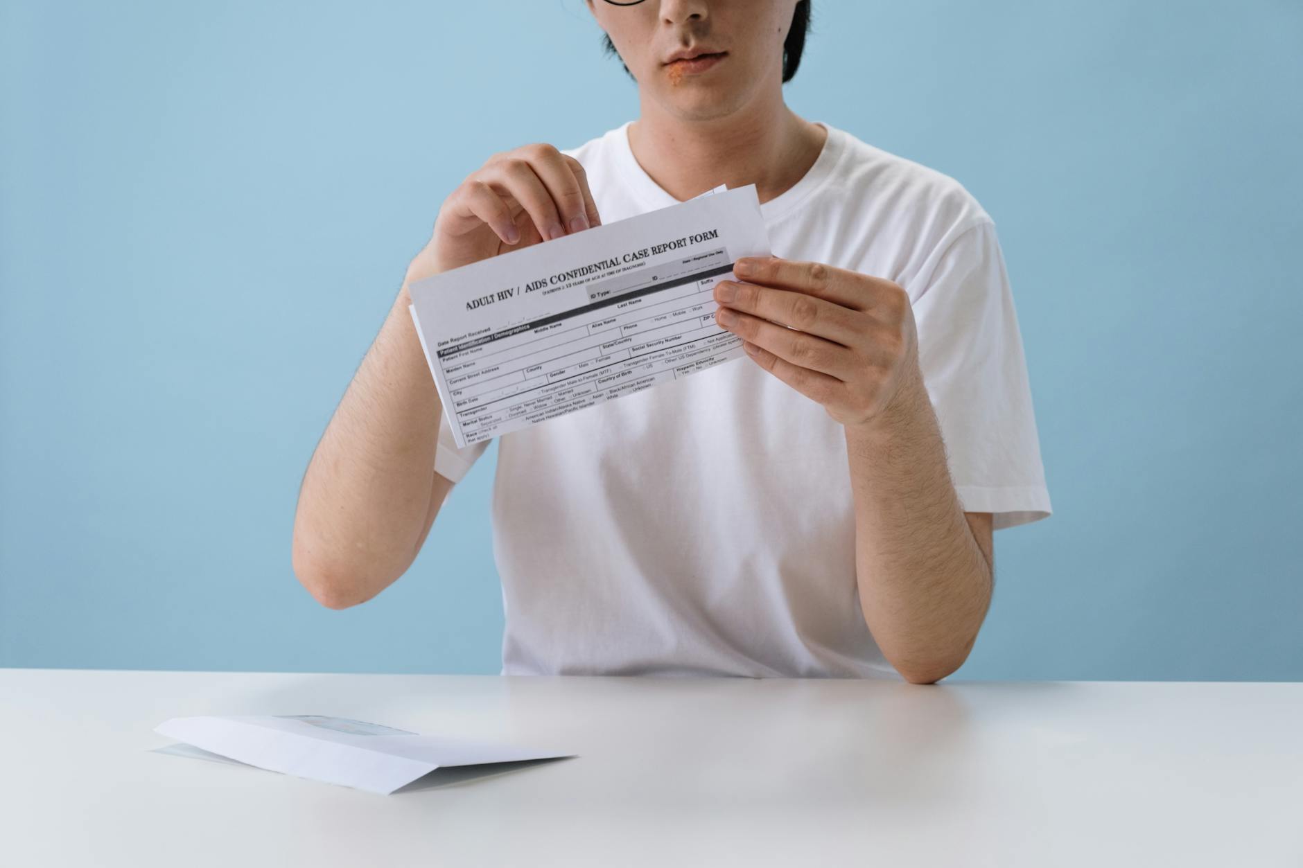 person wearing white shirt and putting sample in plastic bag