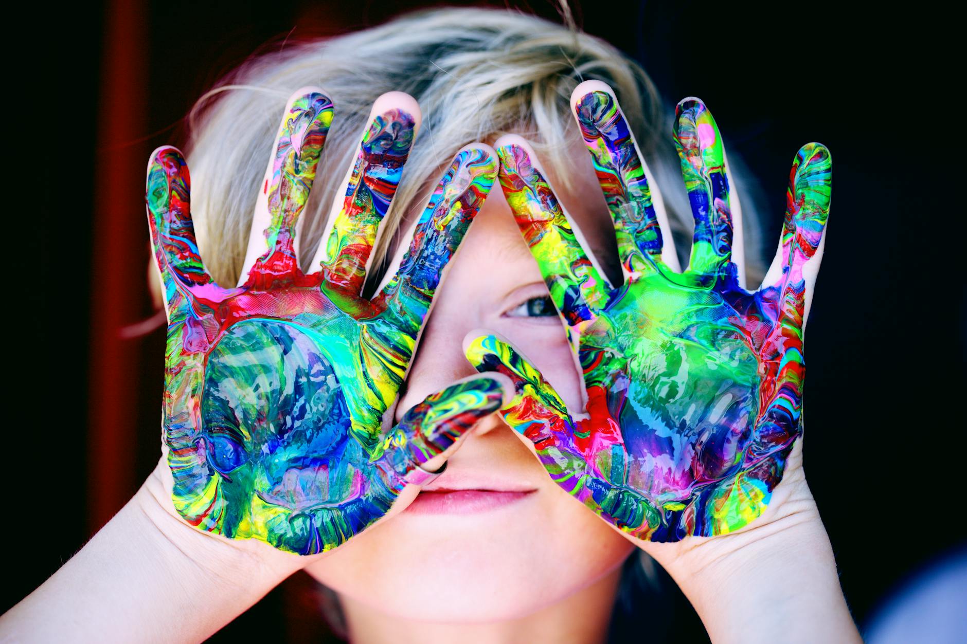 child with paint on palms of hands