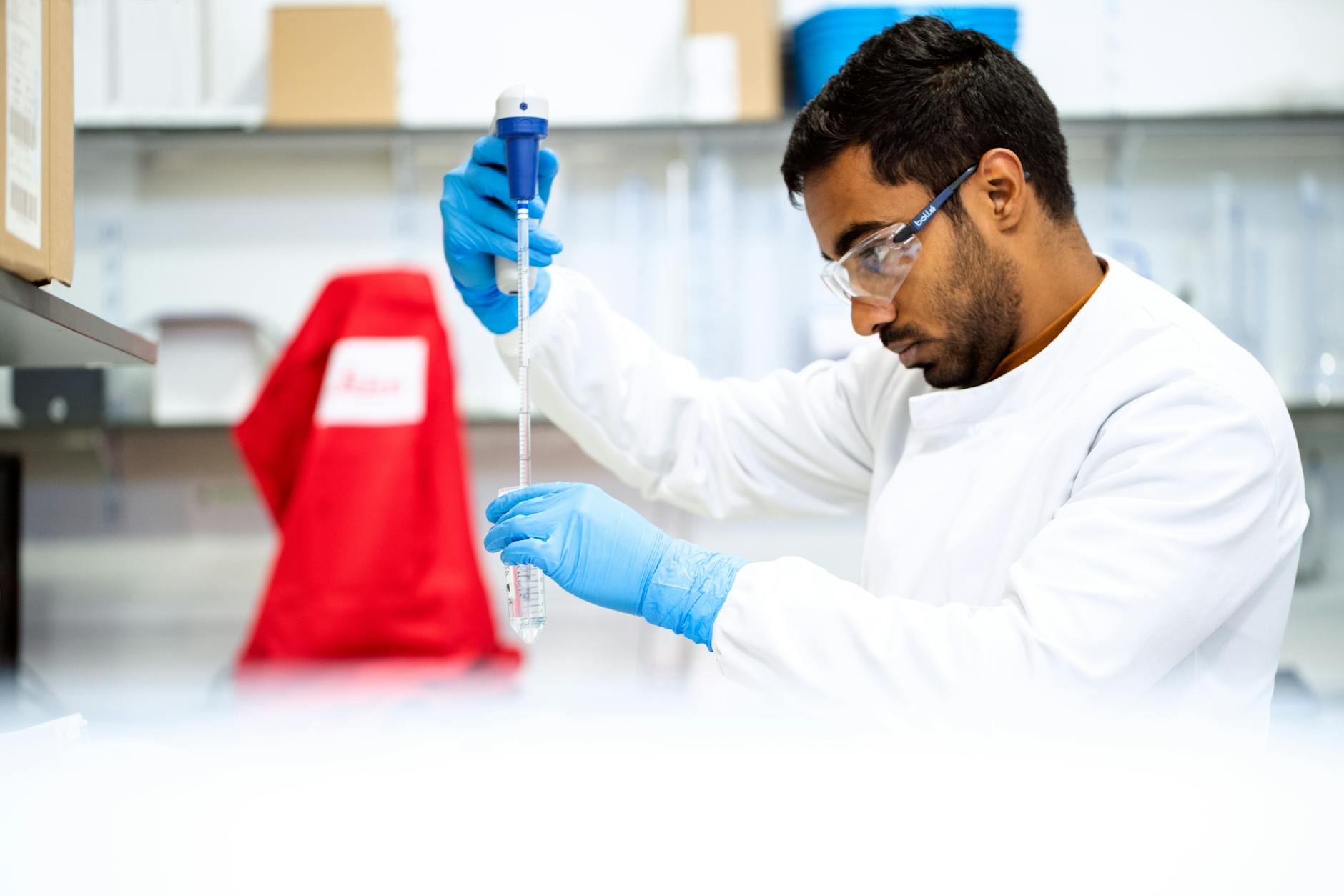 person pipetting in lab